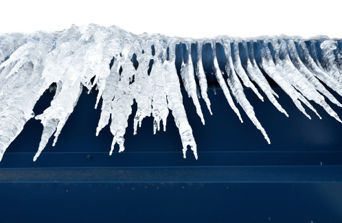 Icicles hanging down from a building roof.